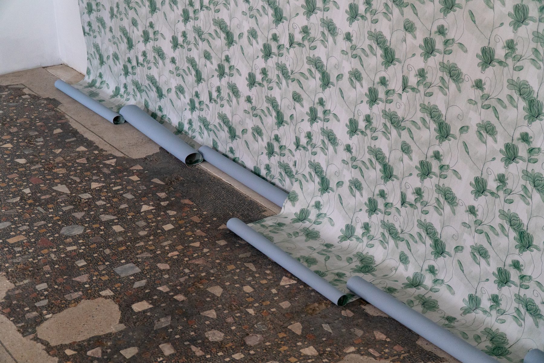 Floating Homes exhibition, wallpaper rolling over ancient mosaic floor