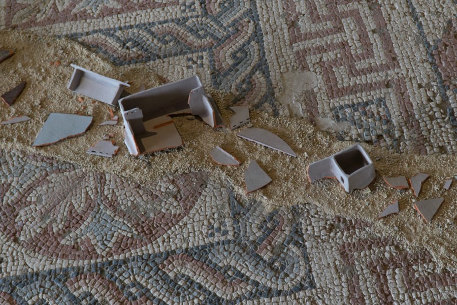 Floating Homes exhibition, broken ceramic domestic objects scattered across ancient mosaic floor
